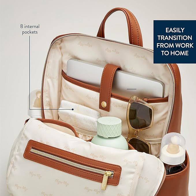 Itzy Ritzy Eras Diaper Bag Backpack – Large Capacity Backpack Diaper Bag Featuring Sleek Design, 15 Pockets, Changing Pad, Stroller Straps, and Luggage Sleeve (Cognac)